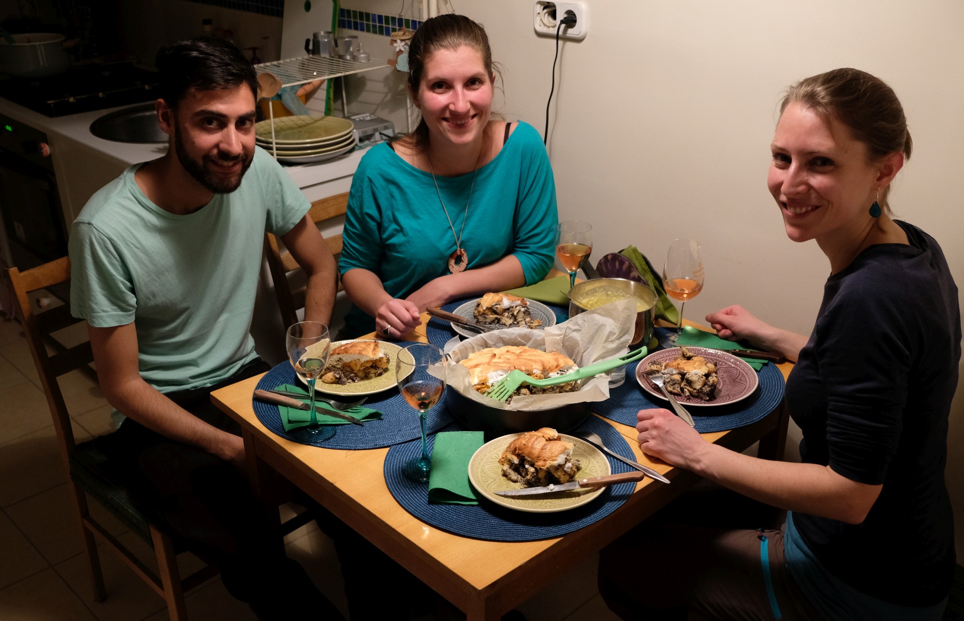 Lali, Dorka und Leo sitzen an einem gedeckten Tisch