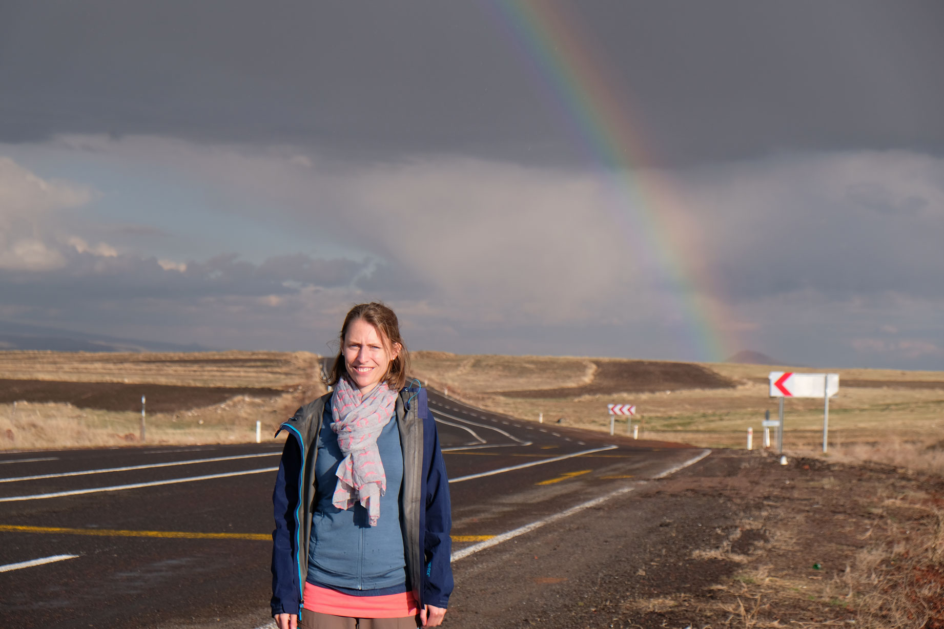 Leo steht auf einer Straße vor einem Regenbogen