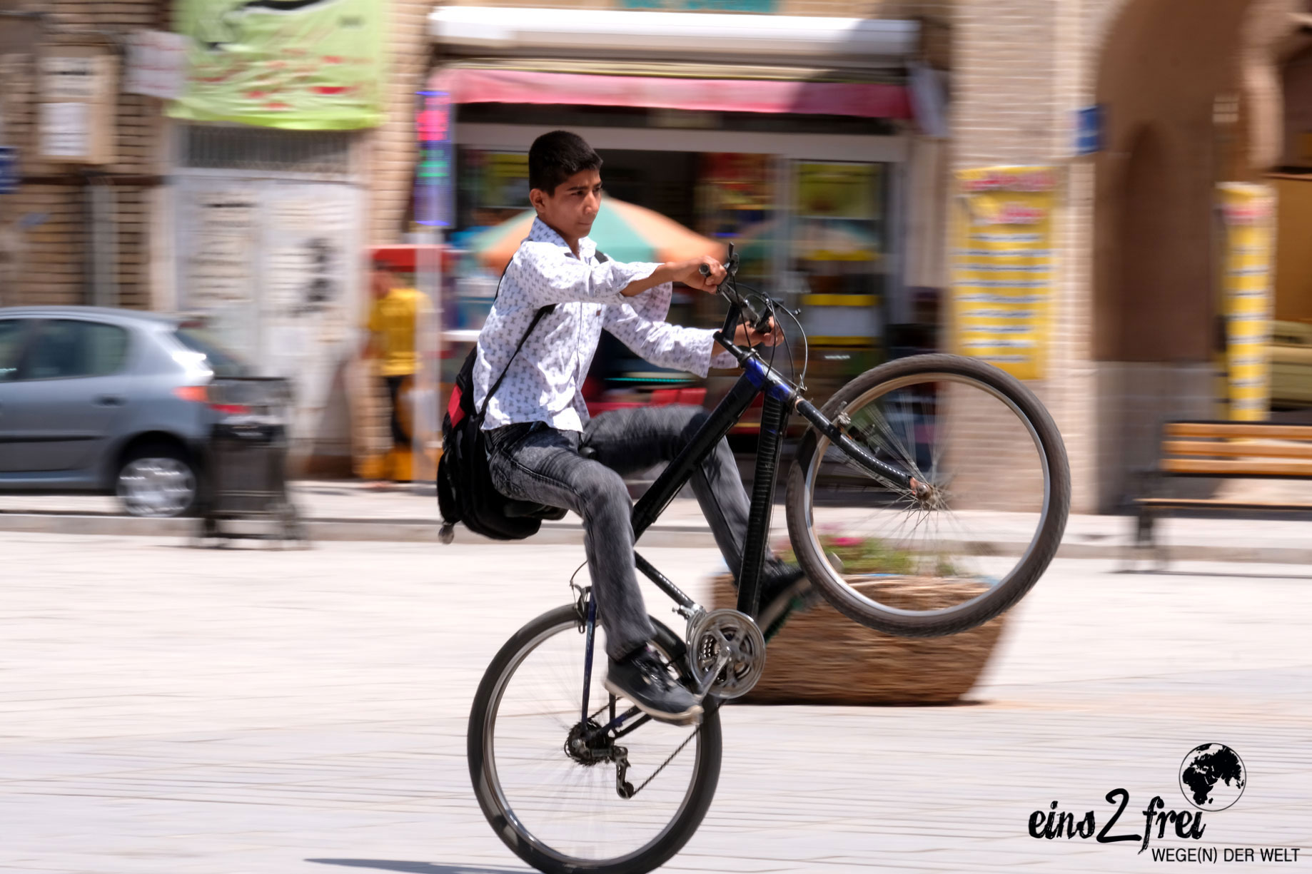 Ein Junge macht mit seinem Fahrrad einen Wheelie