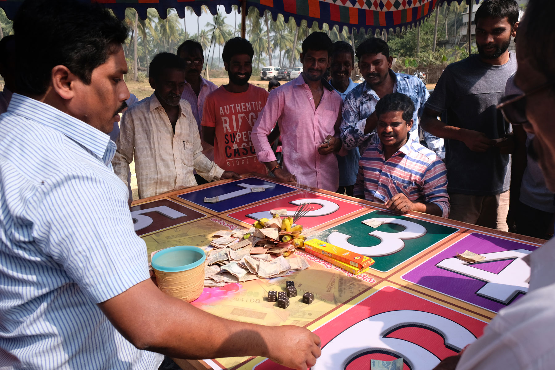 Mensch stehen um ein Glücksspiel beim Sankranthi Festival in Indien.