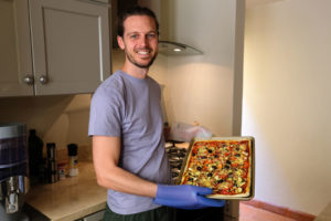 Sebastian zeigt stolz die von ihm gebackene Pizza bei unserem House Sit in San Miguel de Allende in Mexiko.